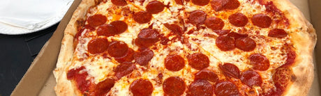 New York Style Pizza Recipe in a wood-fired oven