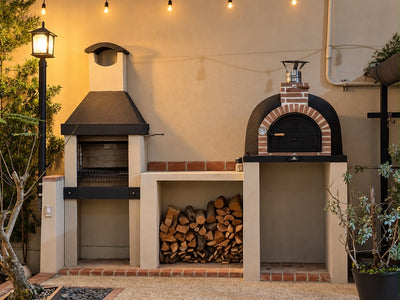 Argentine Grill ECO Mini and a Traditional Wood-Fired Oven built into a patio with firewood storage