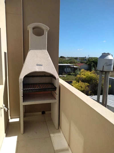 Compact grill with hood on a balcony