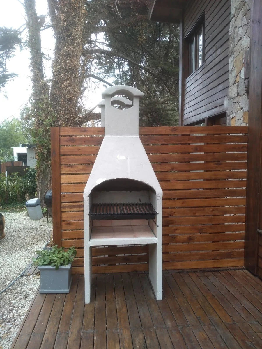 Argentine grill with hood on a wooden deck