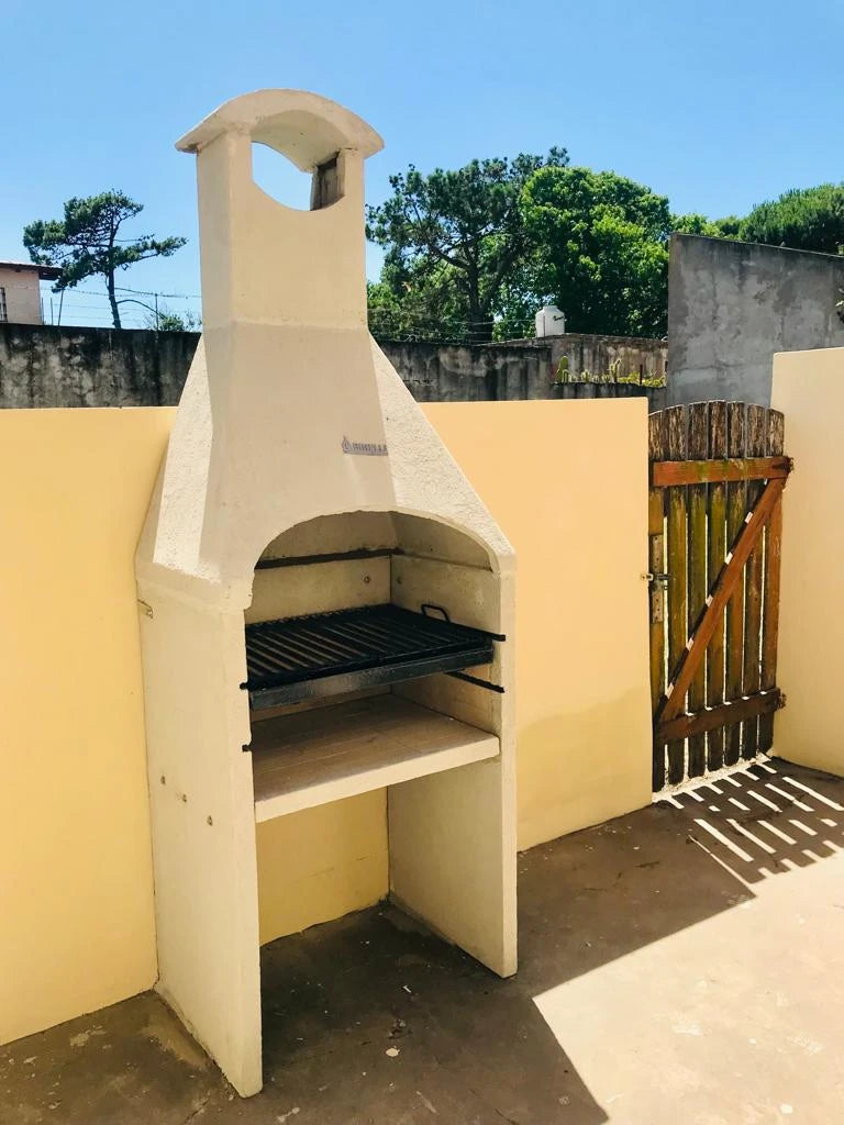 Refractory concrete grill with hood on a patio